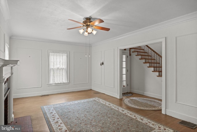 15 E Grant St, Woodstown, NJ 08098 - foyer entrance featuring ceiling fan, ornamental molding, stairway, wood finished floors, and baseboards