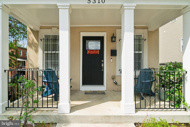 5310 B St SE, Washington, DC 20019 - doorway to property featuring a porch and stucco siding