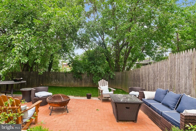 5310 B St SE, Washington, DC 20019 - fenced backyard with an outdoor living space with a fire pit and a patio area
