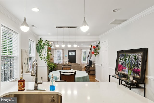 5310 B St SE, Washington, DC 20019 - kitchen with a sink, ornamental molding, hanging light fixtures, recessed lighting, and light countertops