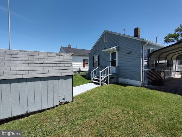 427 Camper St, Cambridge, MD 21613 - rear view of property featuring a detached carport and a chimney