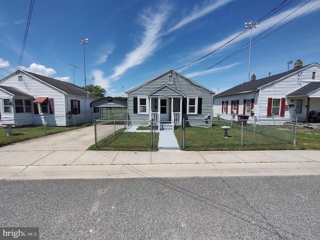 427 Camper St, Cambridge, MD 21613 - view of front of property featuring concrete driveway, a gate, a porch, and a detached carport