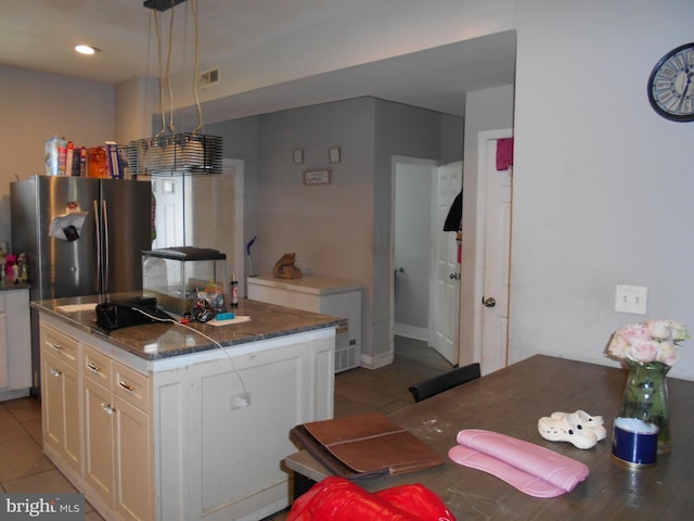 4708 Frederick Ave, Baltimore, MD 21229 - kitchen featuring freestanding refrigerator, white cabinetry, refrigerator, a center island, and dark countertops