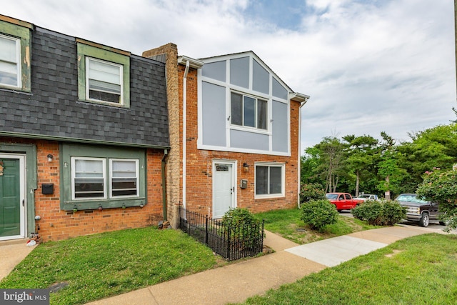 231 Ivanhoe Ct, Fredericksburg, VA 22401 - view of property featuring a front yard, brick siding, and roof with shingles
