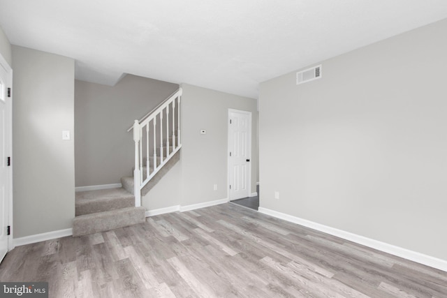 231 Ivanhoe Ct, Fredericksburg, VA 22401 - unfurnished living room featuring wood finished floors, stairway, and baseboards