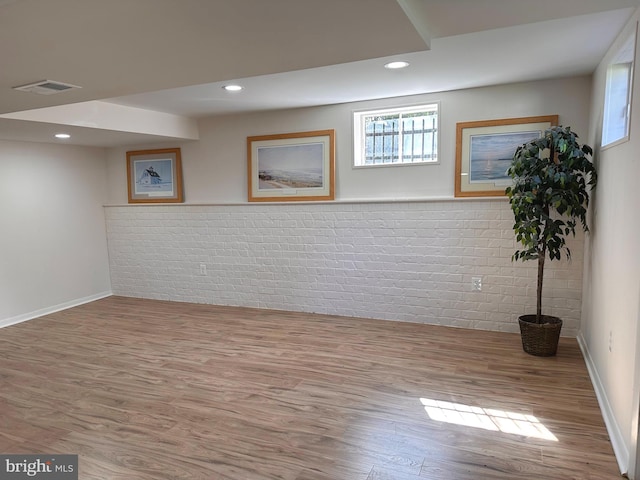 5420 Eastbourne Dr, Springfield, VA 22151 - basement featuring wood finished floors, plenty of natural light, brick wall, baseboards, and recessed lighting