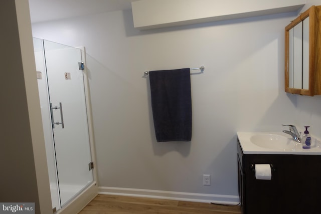 413 Dominion Rd, Chester, MD 21619 - full bathroom featuring wood finished floors, vanity, baseboards, and a stall shower