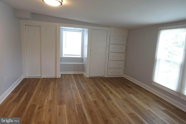 413 Dominion Rd, Chester, MD 21619 - unfurnished bedroom with multiple windows, light wood-style floors, and baseboards