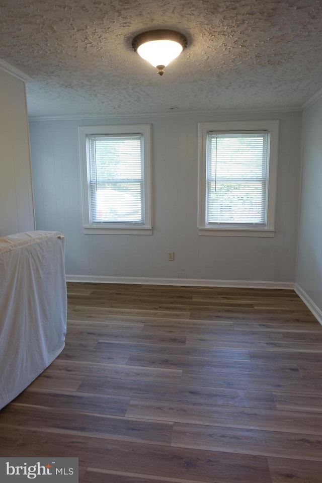 413 Dominion Rd, Chester, MD 21619 - empty room featuring a textured ceiling, healthy amount of natural light, dark wood finished floors, crown molding, and baseboards