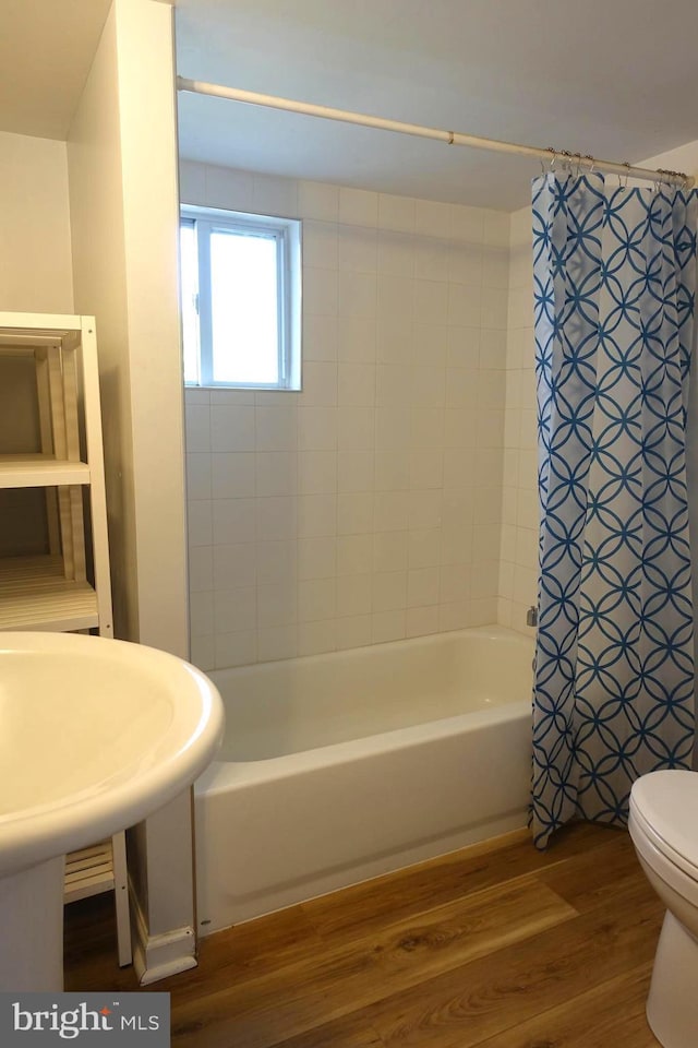 413 Dominion Rd, Chester, MD 21619 - bathroom with wood finished floors, shower / tub combo with curtain, and toilet