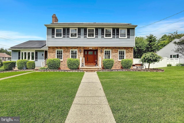 199 Applegate, Hamilton, NJ 08690 - colonial-style house featuring brick siding, a chimney, and solar panels