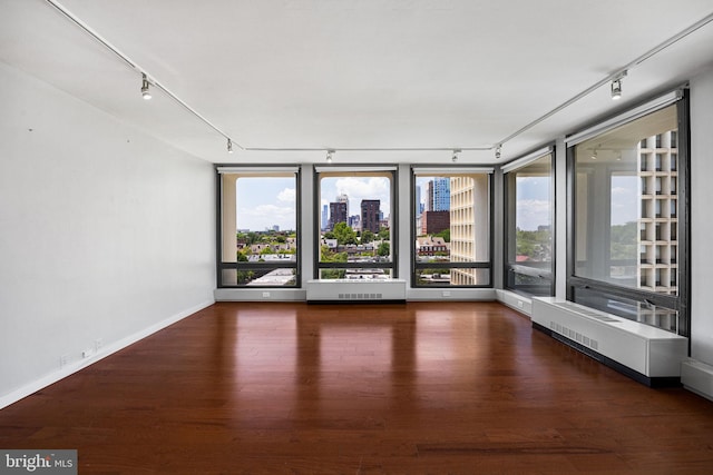 220 Locust St Unit 7As, Philadelphia, PA 19106 - unfurnished room with rail lighting, wood finished floors, a view of city, and healthy amount of natural light