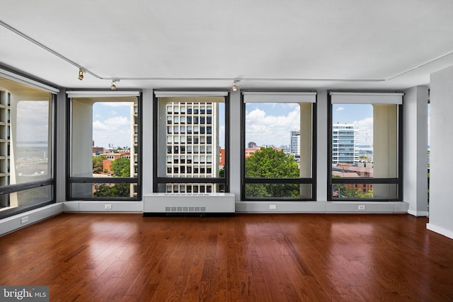 220 Locust St Unit 7As, Philadelphia, PA 19106 - spare room featuring wood finished floors, rail lighting, a city view, and radiator