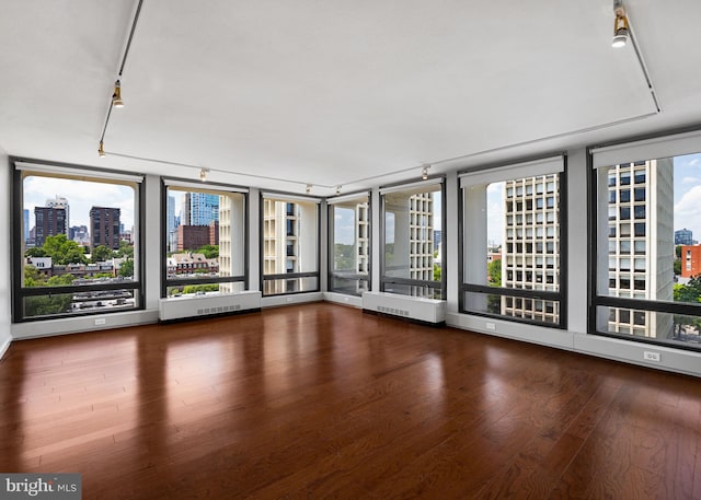 220 Locust St Unit 7As, Philadelphia, PA 19106 - spare room with a city view, wood finished floors, healthy amount of natural light, and rail lighting