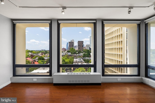 220 Locust St Unit 7As, Philadelphia, PA 19106 - spare room featuring rail lighting, wood finished floors, and a view of city