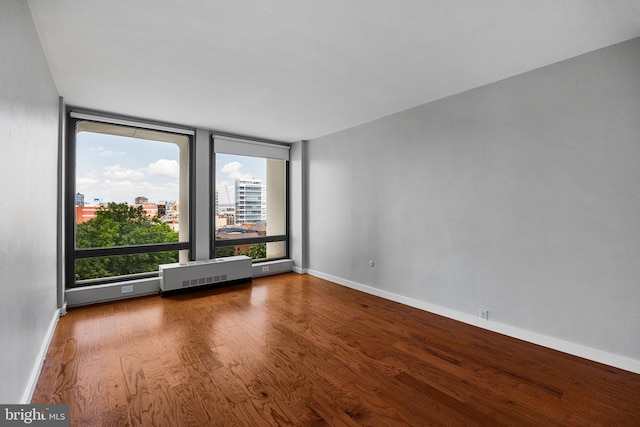 220 Locust St Unit 7As, Philadelphia, PA 19106 - spare room with wood finished floors, radiator heating unit, and a view of city