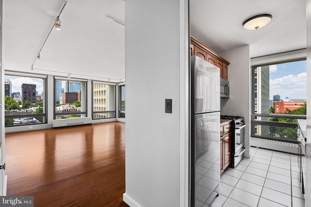 220 Locust St Unit 7As, Philadelphia, PA 19106 - kitchen with stainless steel appliances, a city view, rail lighting, light wood-type flooring, and open floor plan