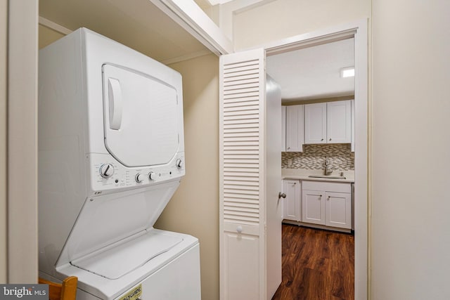 8370 Greensboro Dr Unit 508, Mclean, VA 22102 - washroom featuring stacked washing machine and dryer and dark wood-style floors