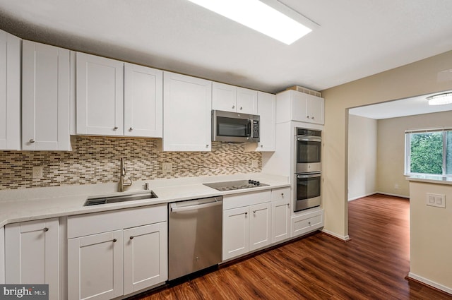 8370 Greensboro Dr Unit 508, Mclean, VA 22102 - kitchen with appliances with stainless steel finishes, a sink, backsplash, and dark wood finished floors
