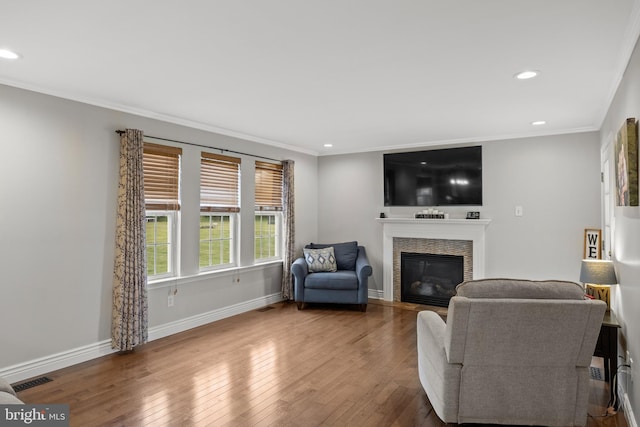 545 Lawrence Corner Rd, Pittsgrove, NJ 08318 - living area featuring ornamental molding, recessed lighting, a glass covered fireplace, wood-type flooring, and baseboards