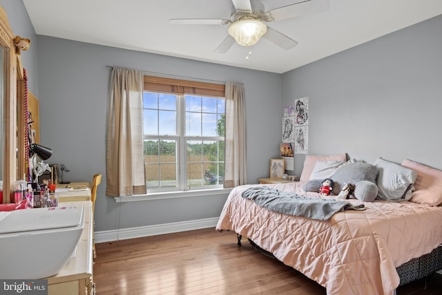 545 Lawrence Corner Rd, Pittsgrove, NJ 08318 - bedroom with wood finished floors, baseboards, a sink, and ceiling fan