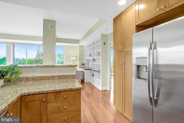 513 W Broad St Unit 602, Falls Church, VA 22046 - kitchen featuring stainless steel refrigerator with ice dispenser, light wood finished floors, light stone countertops, healthy amount of natural light, and recessed lighting