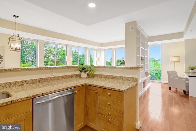 513 W Broad St Unit 602, Falls Church, VA 22046 - kitchen with stainless steel dishwasher, light stone countertops, pendant lighting, light wood-type flooring, and a chandelier
