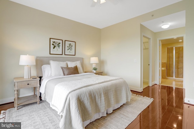 513 W Broad St Unit 602, Falls Church, VA 22046 - bedroom with baseboards, connected bathroom, and a ceiling fan