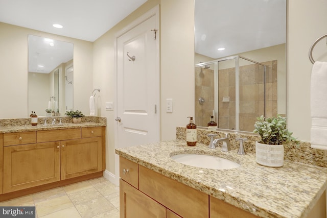 513 W Broad St Unit 602, Falls Church, VA 22046 - full bathroom with two vanities, a shower stall, recessed lighting, and baseboards