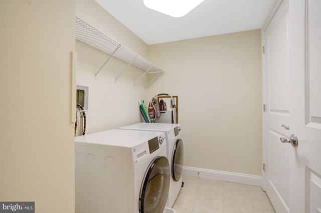 513 W Broad St Unit 602, Falls Church, VA 22046 - laundry area with washing machine and dryer, baseboards, and light tile patterned floors