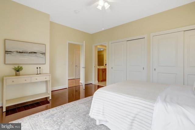 513 W Broad St Unit 602, Falls Church, VA 22046 - bedroom featuring two closets, wood finished floors, baseboards, and ceiling fan