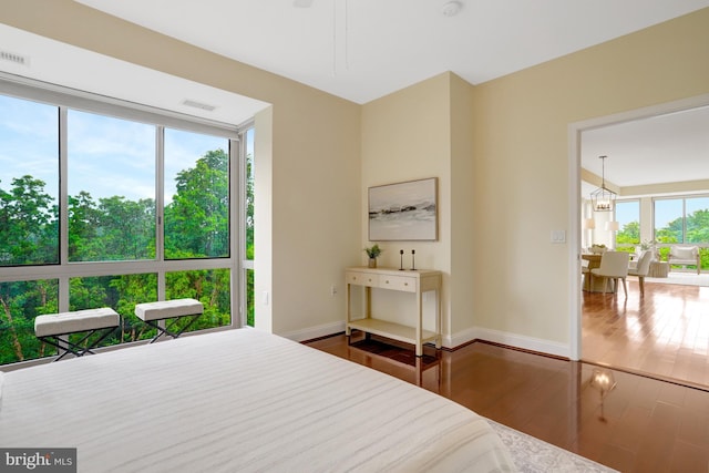513 W Broad St Unit 602, Falls Church, VA 22046 - bedroom with wood finished floors, baseboards, and a chandelier