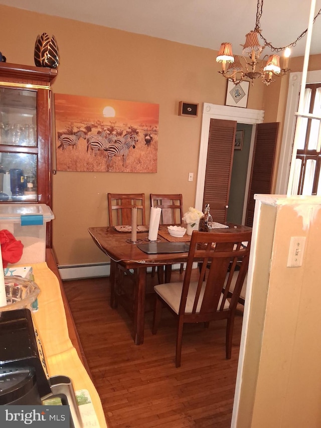 553 Centre Ave, Reading, PA 19601 - dining area with wood finished floors, a chandelier, and baseboard heating