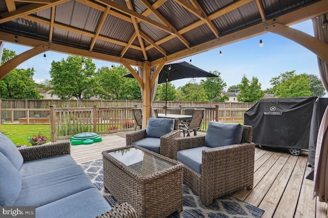 9977 Mallow Ct, Manassas, VA 20110 - wooden deck with a fenced backyard, a gazebo, and outdoor lounge area