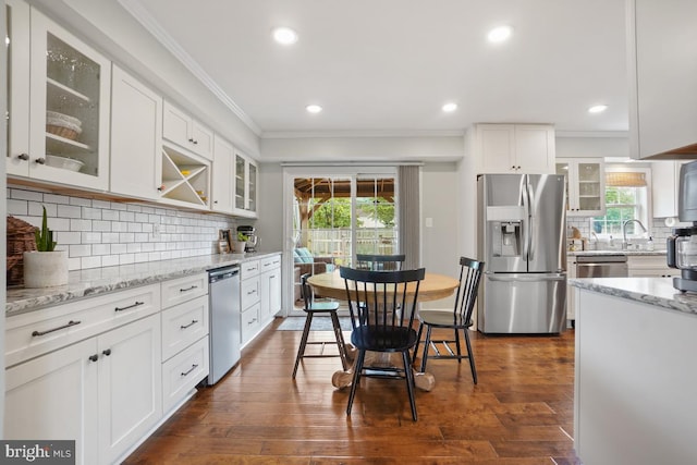 9977 Mallow Ct, Manassas, VA 20110 - kitchen with appliances with stainless steel finishes, ornamental molding, decorative backsplash, plenty of natural light, and white cabinets