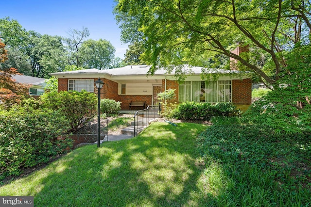 8008 Park Crest Dr, Silver Spring, MD 20910 - back of house with brick siding, a yard, and a chimney
