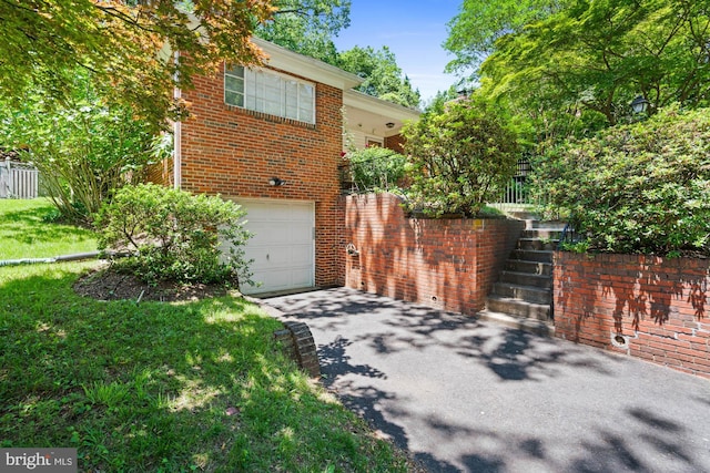 8008 Park Crest Dr, Silver Spring, MD 20910 - view of home's exterior with an attached garage, asphalt driveway, brick siding, and stairway
