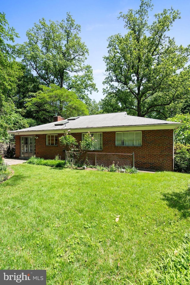 8008 Park Crest Dr, Silver Spring, MD 20910 - ranch-style house featuring a front yard, french doors, brick siding, and a chimney