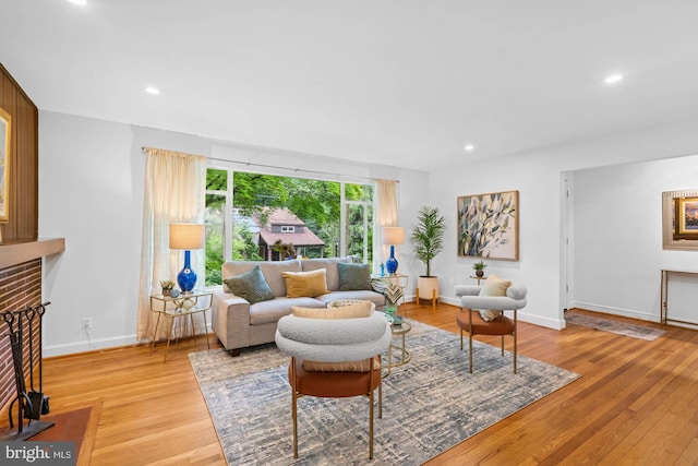 8008 Park Crest Dr, Silver Spring, MD 20910 - living area with light wood-type flooring, recessed lighting, and a brick fireplace