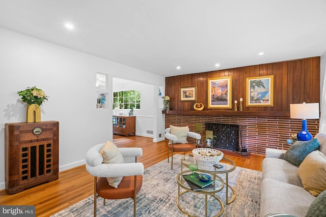 8008 Park Crest Dr, Silver Spring, MD 20910 - living area with recessed lighting, a brick fireplace, wood finished floors, and wooden walls
