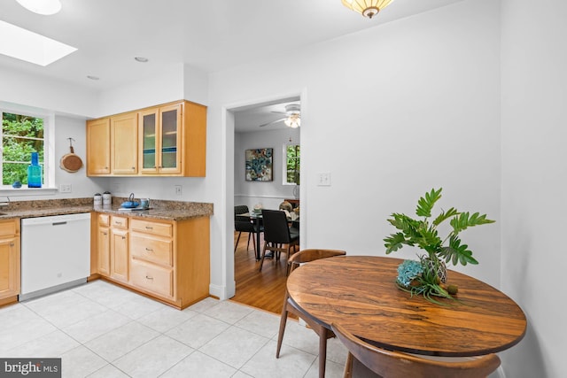 8008 Park Crest Dr, Silver Spring, MD 20910 - kitchen with white dishwasher, light brown cabinets, a skylight, glass insert cabinets, and light tile patterned floors