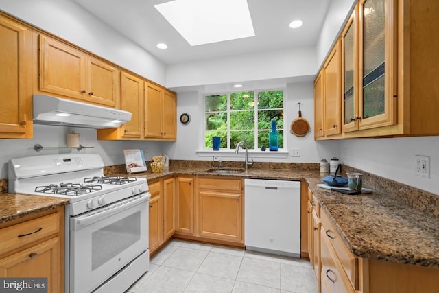 8008 Park Crest Dr, Silver Spring, MD 20910 - kitchen featuring white appliances, under cabinet range hood, a skylight, light tile patterned flooring, and glass insert cabinets