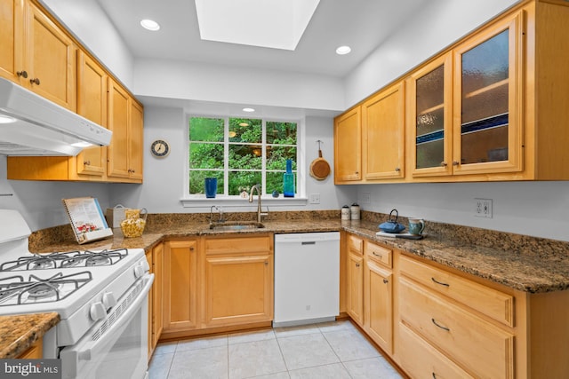 8008 Park Crest Dr, Silver Spring, MD 20910 - kitchen with white appliances, a skylight, under cabinet range hood, light tile patterned floors, and glass insert cabinets