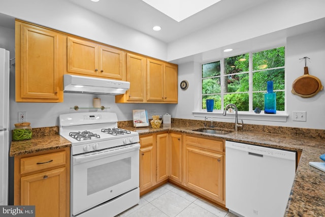 8008 Park Crest Dr, Silver Spring, MD 20910 - kitchen featuring white appliances, under cabinet range hood, dark stone countertops, recessed lighting, and a skylight