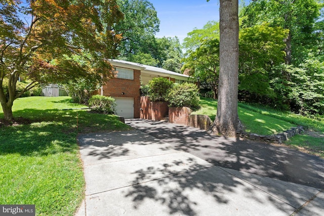 8008 Park Crest Dr, Silver Spring, MD 20910 - view of front of house with brick siding, driveway, an attached garage, and a front yard