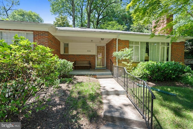 8008 Park Crest Dr, Silver Spring, MD 20910 - doorway to property featuring brick siding, a chimney, and a porch