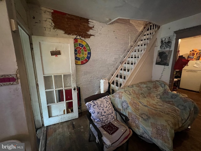 3833 Wyalusing Ave, Philadelphia, PA 19104 - living area with brick wall, wood finished floors, and washer / dryer