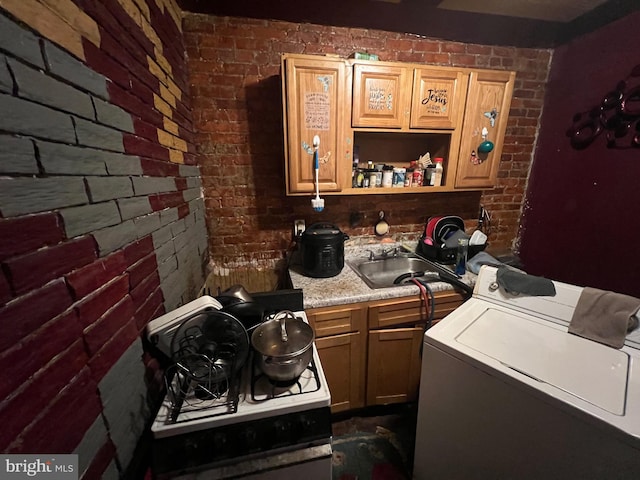 3833 Wyalusing Ave, Philadelphia, PA 19104 - bar featuring washer / dryer, brick wall, a sink, and white range with gas cooktop