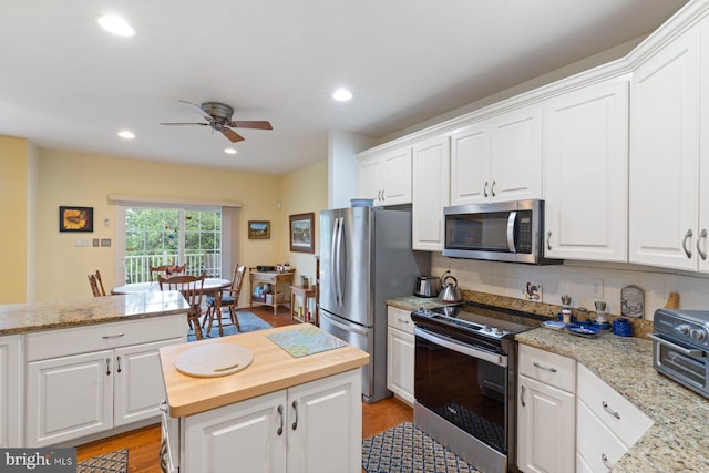 5353 Walkerwood Ct, Manchester, MD 21102 - kitchen with appliances with stainless steel finishes, butcher block counters, a ceiling fan, white cabinets, and recessed lighting