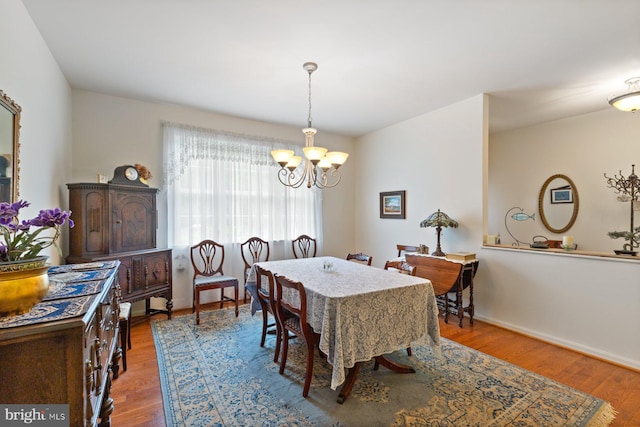 5353 Walkerwood Ct, Manchester, MD 21102 - dining room featuring a chandelier, wood finished floors, and baseboards